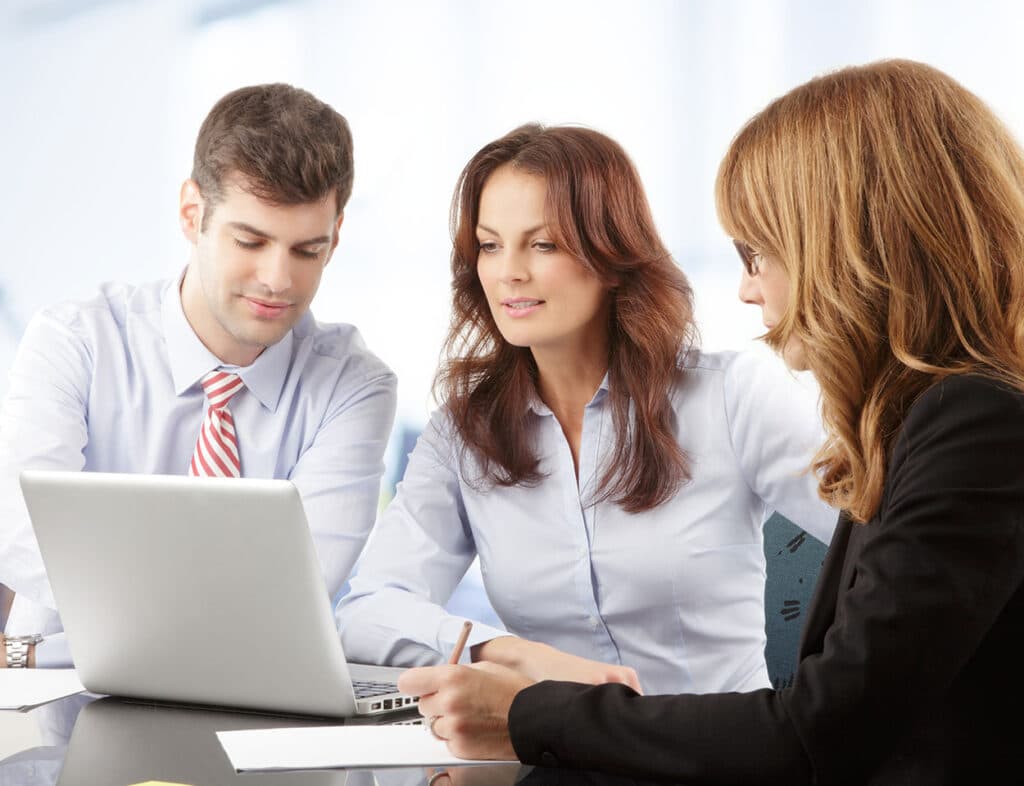 Agents loolking at laptop